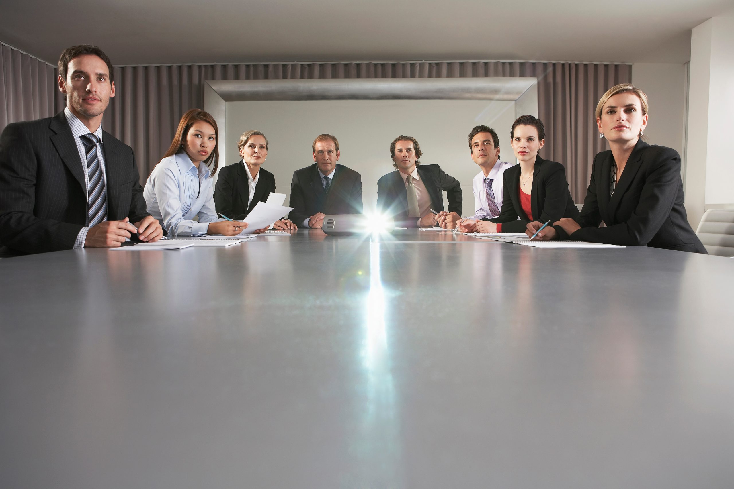 Business People Watching Presentation In Conference Room
